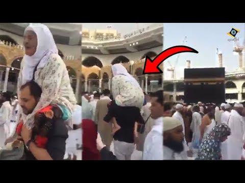 شاهد شاب يحمل والدته ويطوف بها حول الكعبة وهو صائم