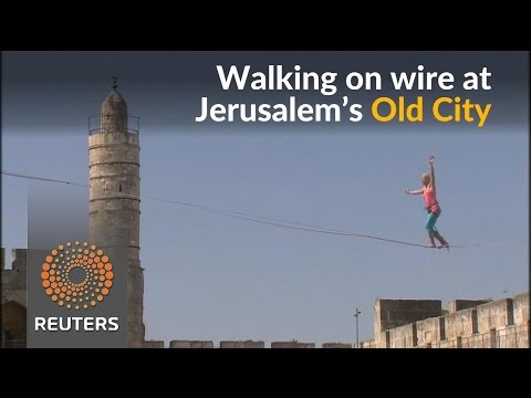 american slackliner walks between jerusalems ancient towers
