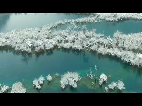 aerial footage shows snowy scenes